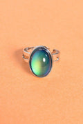 Close-up of Retro Aura Mood Ring with silver band and color-changing oval stone displaying 90s vintage style