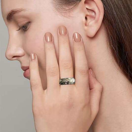 Close-up of an elegant engraved flower ring with detailed floral patterns and shiny finish
