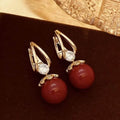 Fashionable pearl earrings with copper alloy, red diamond-like crystals, and elegant design for weddings and parties