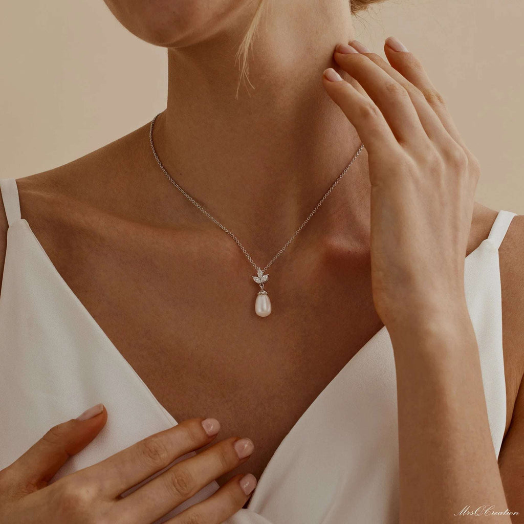 Eternal Pearl & Diamond Necklace – A Whisper of Elegance for Life’s MoGrace Woven in Crystal and PearlThe Eternal Pearl &amp; Diamond Necklace is where timeless beauty meets bridal elegance. Crafted in luminous sterling silver, it featRemoloxEternal Pearl & Diamond Necklace